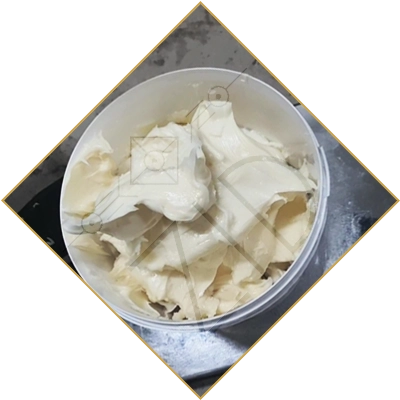 diagonal close-up image of open white sainfoin honey from kyrgyzstan container with golden border